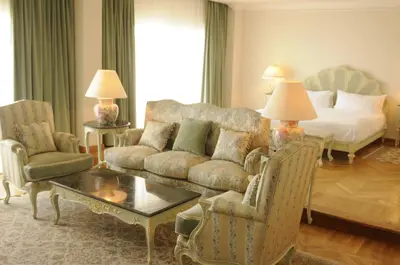 a living room with a couch and a bed at HRG Best Hotel in Hurghada