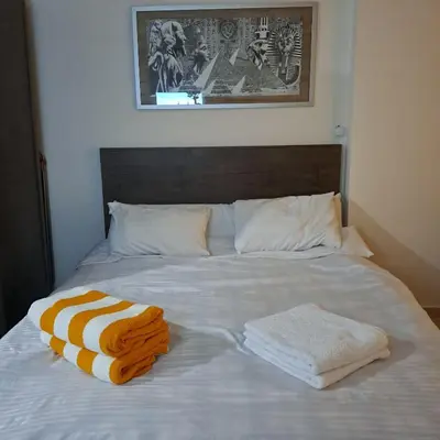 a bed with two towels sitting on top of it at Tiba Golden Beach Resort, Down Town in Hurghada