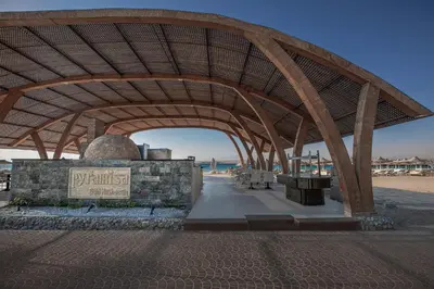 a pavilion at the beach with a sign under it at Pyramisa Beach Resort Sahl Hasheesh in Hurghada