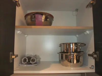 a kitchen shelf with a pot and bowls on it at new in Hurghada