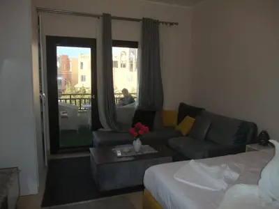 a living room with a couch and a bed at new in Hurghada