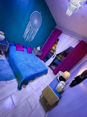 a bedroom with a blue bed and a table at Super luxury hotel apartment in Hurghada