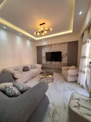 a living room with two couches and a television at Super luxury hotel apartment in Hurghada
