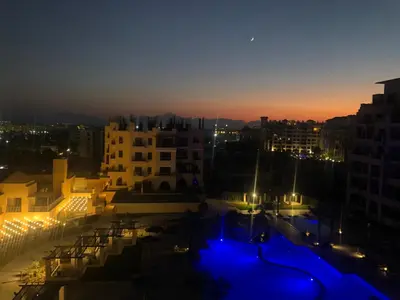 a view of a city at night with blue lights at Super luxury hotel apartment in Hurghada