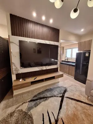 a living room with a large flat screen tv at Super luxury hotel apartment in Hurghada