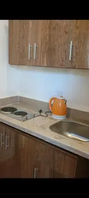 an orange tea kettle sitting on a kitchen counter at شاليه ميراج باى in Hurghada