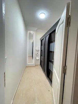 a hallway with a bathroom with a mirror and a door at Hadaba Studio in Hurghada