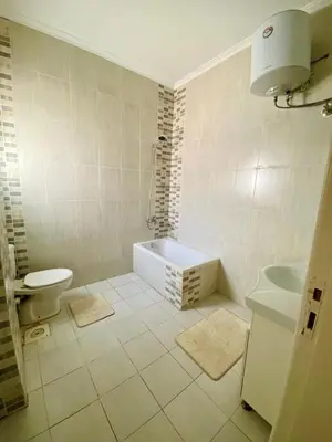 a bathroom with a tub and a toilet and a sink at Magawish villa in the heart of the city in Hurghada