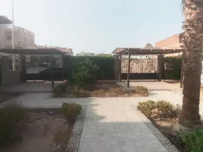 a courtyard with a pavilion and a tree at Magawish villa in the heart of the city in Hurghada