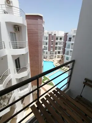 a balcony with a bench and a view of some buildings at Aqua Palms Resort Hurghada in Hurghada