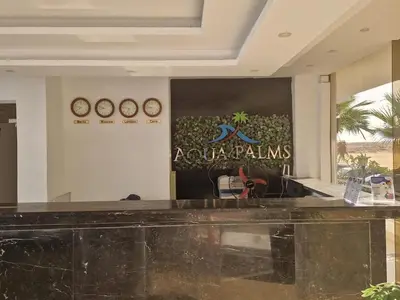 a lobby of a hotel with two clocks on the wall at Aqua Palms Resort Hurghada in Hurghada
