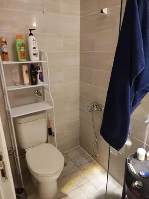 a bathroom with a toilet and a blue towel at Aqua Palms Resort Hurghada in Hurghada