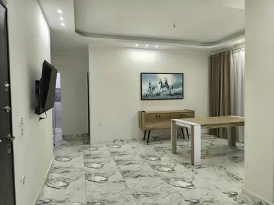 a living room with a table and a piano at New 2bedroom apartment 7 min drive from Sheraton in Hurghada