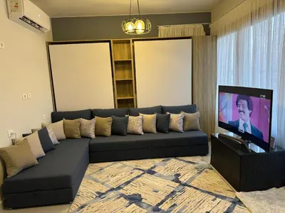 a living room with a couch and a flat screen tv at Mackdi hights in Hurghada