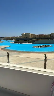 a view of a pool of water with palm trees at Mackdi hights in Hurghada