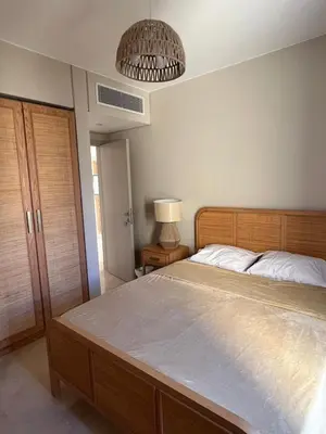 a bedroom with a large bed and a chandelier at M8 free access to the BEACH and POOL in Hurghada