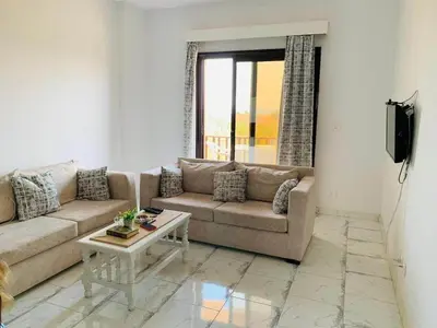 a living room with a couch and a table at One Bedroom At Turtle Beach Compound With Private Beach in Hurghada