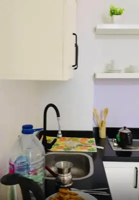 a kitchen sink with a bottle of water and a plate of food at One Bedroom At Turtle Beach Compound With Private Beach in Hurghada