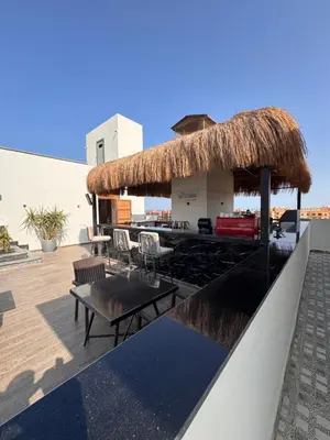 a restaurant with a thatched roof with tables and chairs at Imperial resort Hurgarda in Hurghada