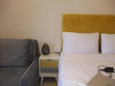 a bed and a couch in a small room at Victoria Aldau Heights Hurghada rent one bedroom Apartment in Hurghada