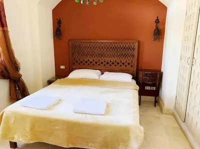 a bedroom with a large bed with two towels on it at Private Villa with heated pool and lagoon in Hurghada