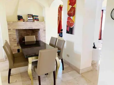 a dining room with a table and chairs and a fireplace at Private Villa with heated pool and lagoon in Hurghada
