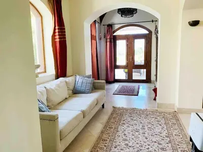 a living room with a couch and an arched doorway at Private Villa with heated pool and lagoon in Hurghada