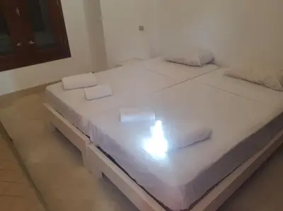 a white bed with two white towels on it at Villa, with heated Pool and Lagoon in Hurghada