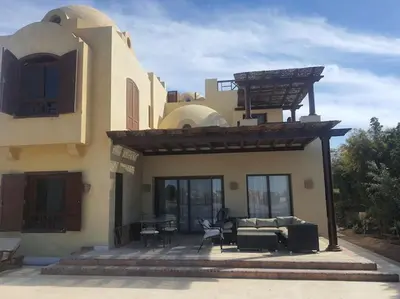 a house with a living room and a patio at Villa, with heated Pool and Lagoon in Hurghada