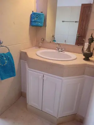 a bathroom with a white sink and a mirror at Cozy villa with private pool in Upper Nubia in Hurghada