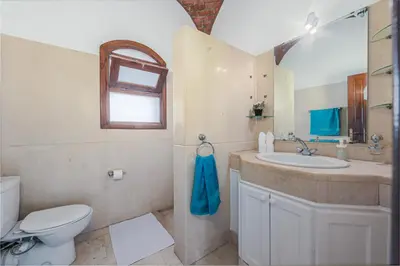 a bathroom with a sink and a toilet and a window at Cozy villa with private pool in Upper Nubia in Hurghada