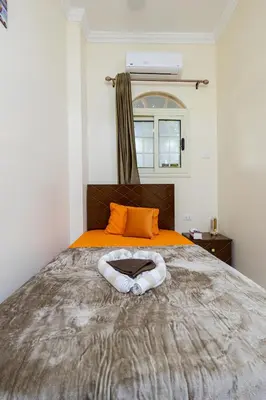 a bedroom with a bed with a white oar on it at Samara Guest House in Aswan