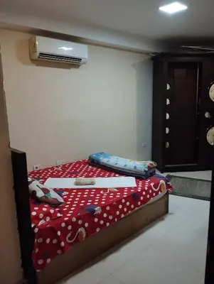 a bedroom with a bed with a red comforter at City center NewAswan Aswan 2 in Aswan