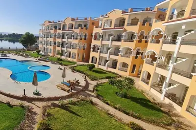 an aerial view of a resort with a swimming pool at Nile Front Luxor Apt Sleeps 6 with Pool in Luxor
