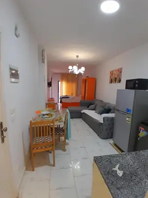 a kitchen and living room with a couch and a table at Turtles Beach resort hourghada Studio view sea view pool private beach jacuzzi pools air-conditioned restaurant on the beach jacuzzi security and a large sunny balcony in Hurghada