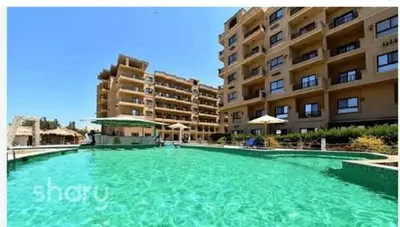 a large swimming pool in front of a building at Turtles Beach resort hourghada Studio view sea view pool private beach jacuzzi pools air-conditioned restaurant on the beach jacuzzi security and a large sunny balcony in Hurghada