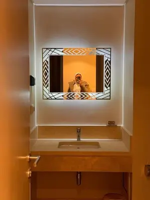 a person taking a picture of a bathroom sink at Amazing Mangroovy 1 BD in gouna in Hurghada