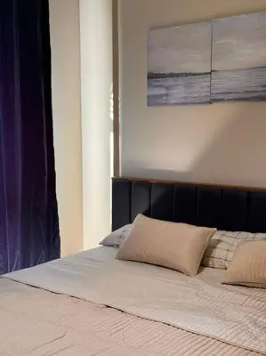 a bed with two pillows on top of it at Amazing Mangroovy 1 BD in gouna in Hurghada