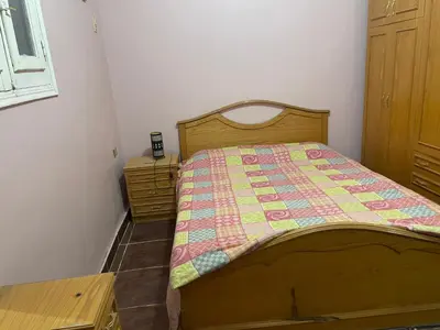 a bedroom with a bed with a quilt on it at MelissaKato in Naj‘ al Maḩaţţah