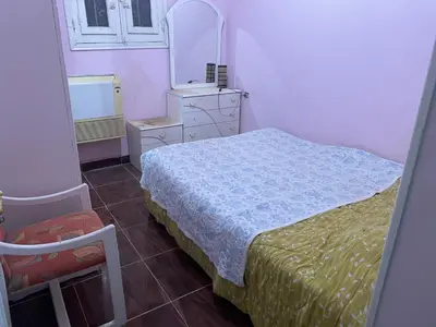 a small bedroom with a bed and a mirror at MelissaKato in Naj‘ al Maḩaţţah