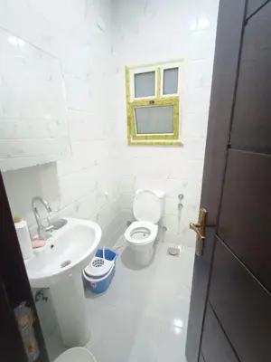 a white bathroom with a toilet and a sink at Juliana beach in Hurghada