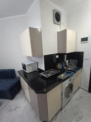 a small kitchen with a stove and a microwave at Juliana beach in Hurghada