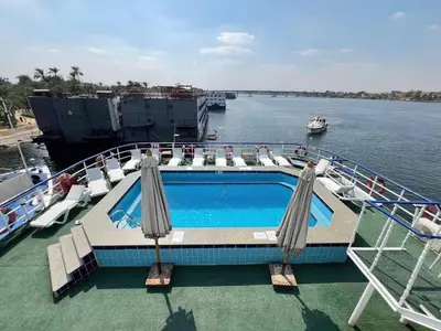 a cruise ship with a swimming pool on the water at Nile Cruise 2 nights 3 Days From Aswan to Luxor with tours in Aswan
