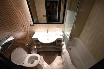 a bathroom with a toilet and a sink and a mirror at Nile Cruise 2 nights 3 Days From Aswan to Luxor with tours in Aswan