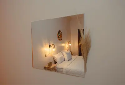 a reflection of a bedroom with a bed in a mirror at Wanees Hostel in Aswan