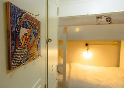 a bedroom with a bunk bed with a painting on the wall at Wanees Hostel in Aswan