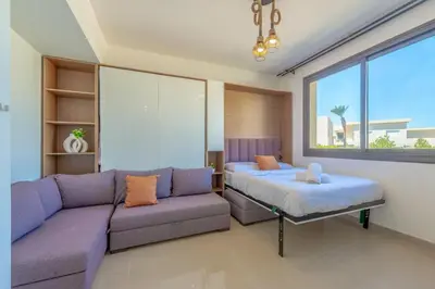 a living room with a couch and a bed at Peaceful 1BR studio at G-Crib El Gouna in Hurghada