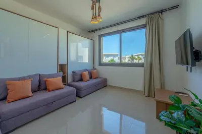 a living room with two couches and a tv at Peaceful 1BR studio at G-Crib El Gouna in Hurghada