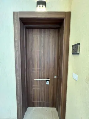 a wooden door in a building with a light above it at Peaceful 1BR studio at G-Crib El Gouna in Hurghada