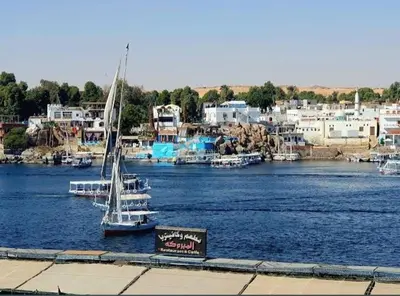 a sail boat is docked in a marina at شقق للإيجار بأسوان in Aswan